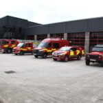 6 vehicles at front of station, Land Rover in foreground