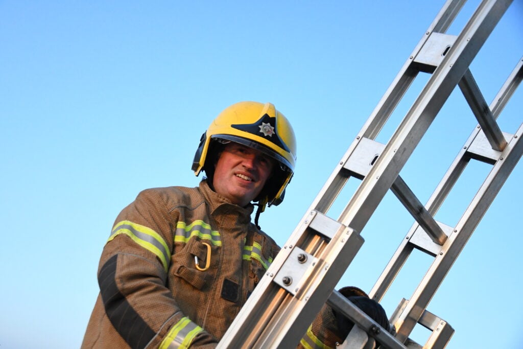 Firefighter up a ladder
