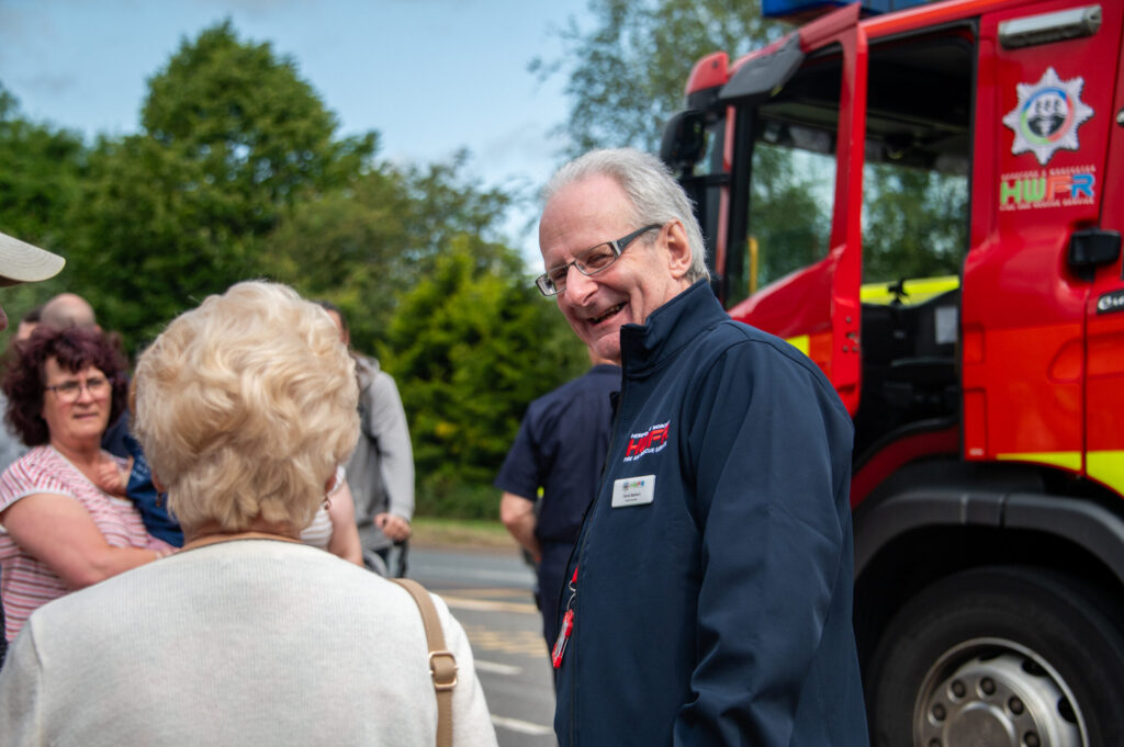 HWFRS volunteer at an event talking to the public