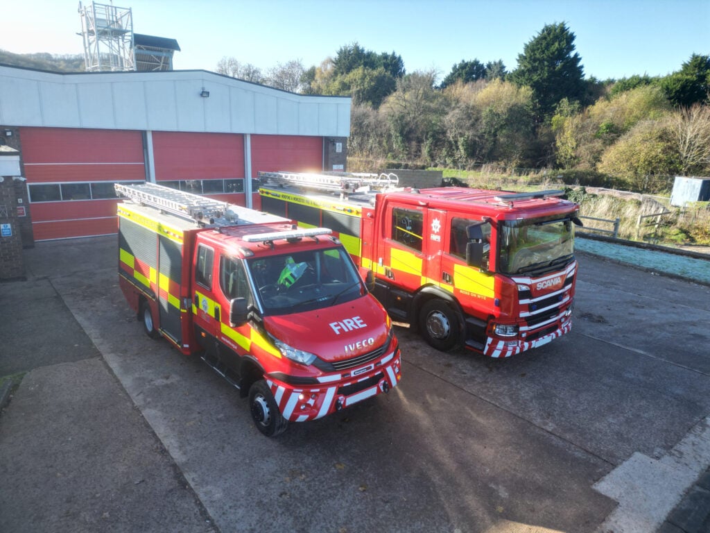 Fire engine and compact fire engine in front of fire station