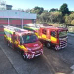 Fire engine and compact fire engine in front of fire station