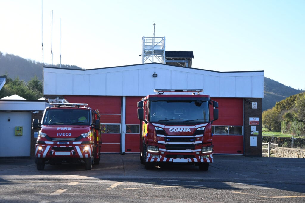 Fire engine and compact fire engine in front of fire station picture taken directly front on