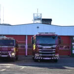 Fire engine and compact fire engine in front of fire station picture taken directly front on