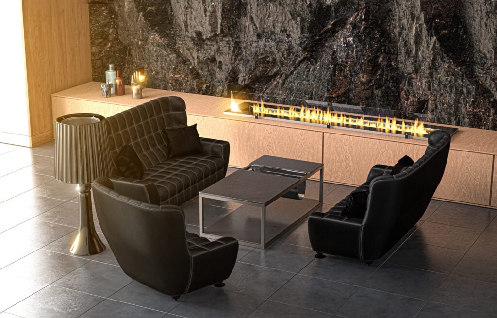 Bioethanol fireplace in a room with three chairs, a table and a lamp